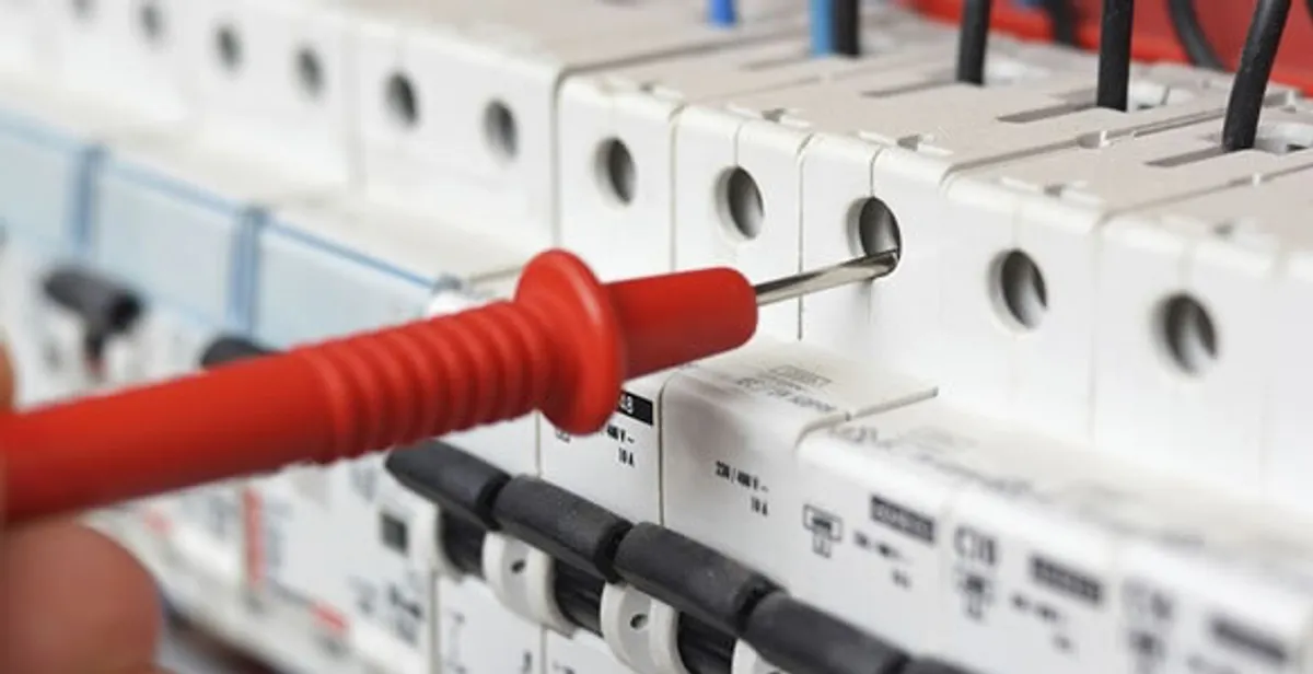 Electrical contractor testing circuit breakers during electrical repair in Dania, FL