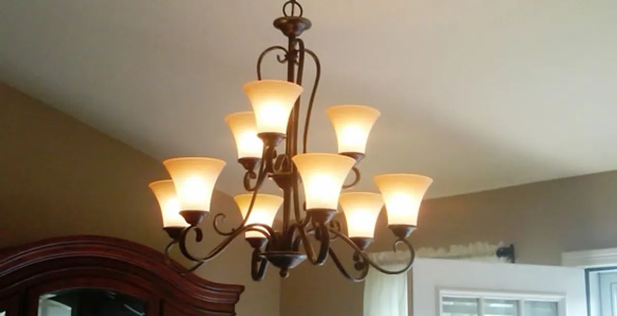 Classic ceiling chandelier installation with warm lighting in Boca Raton, FL