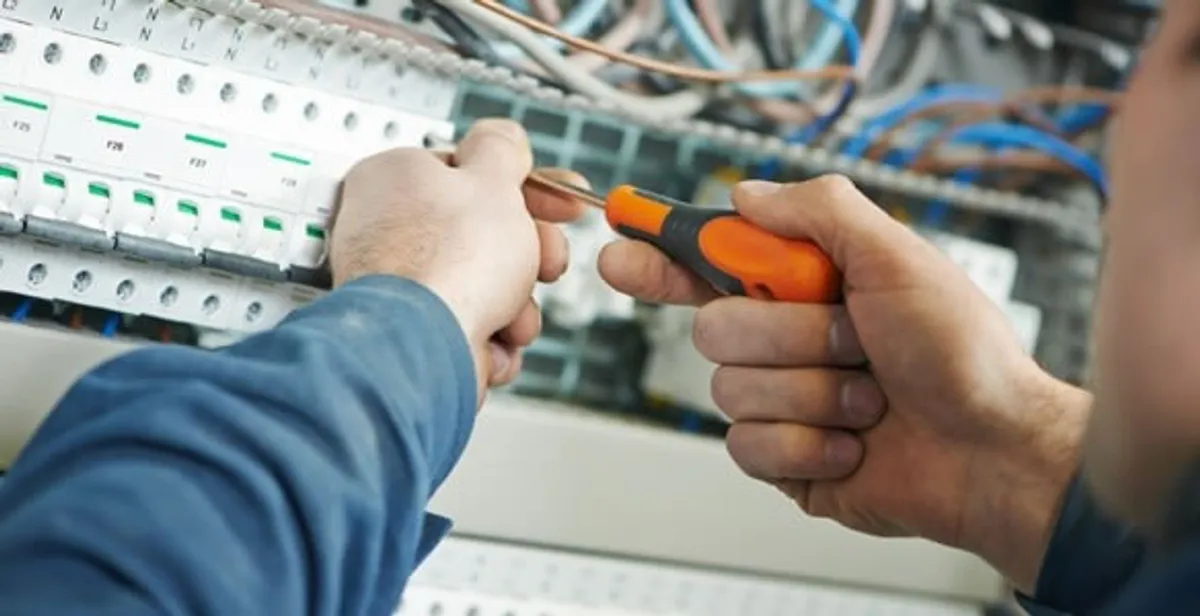 electrical service showing licensed electrician performing electrical panel maintenance and adjustments in Boca Raton, FL