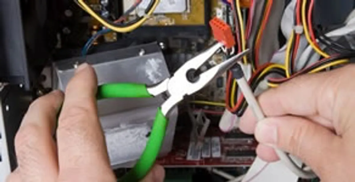 Licensed electrical contractor performing electrical repair with tools in Plantation, FL
